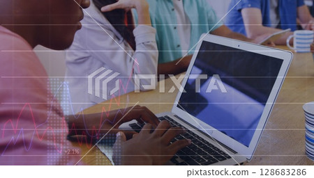 Statistical data processing against african american man using a laptop at office 128683286