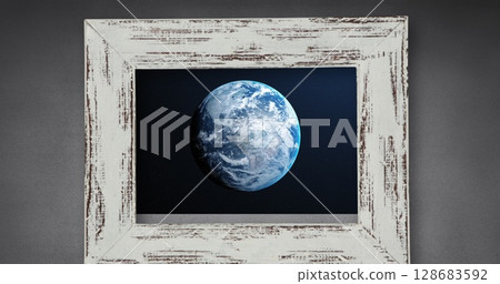 Image of globe in wooden frame on grey background Image of globe in wooden frame on grey background 128683592