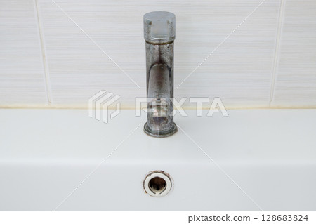 Rusty Metal Faucet with Peeling Chrome. Rusty Metal Faucet with Peeling Chrome. 128683824