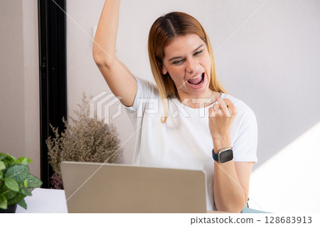 Young caucasian business woman using laptop computer for success in modern home office. 128683913