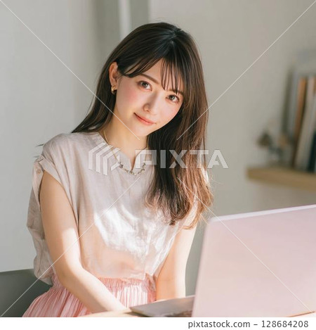 A woman using a personal computer in a room A woman using a personal computer in a room 128684208