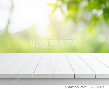 White wooden table and green garden 128684348