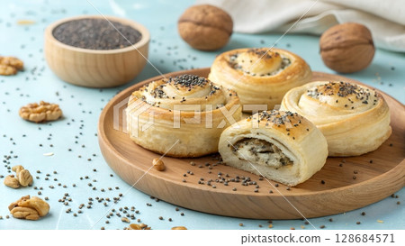 Delicious buns with chia seeds and walnuts sit on a wooden tray, beautifully presented 128684571