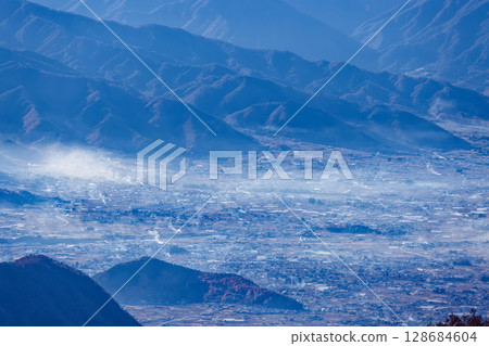 Morning mist wafting through Enzan city as seen from Mount Kentoku and Ogidaira 128684604