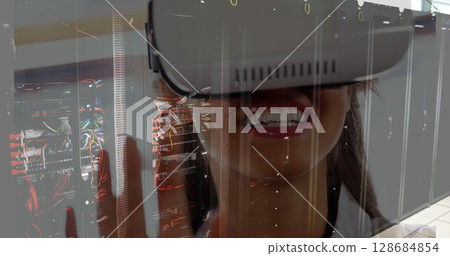 Image of server room over biracial woman using vr headset Image of server room over biracial woman using vr headset 128684854