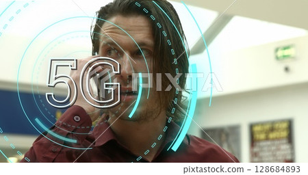 Image of 5g over caucasian businessman using smartphone in office Image of 5g over caucasian businessman using smartphone in office 128684893