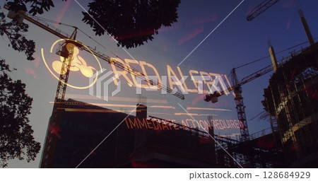 Image of red alert text over building site Image of red alert text over building site 128684929