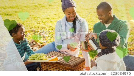 Image of green hearts over picnic basket and african american family in park Image of green hearts over picnic basket and african american family in park 128684970