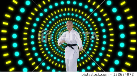 Image of caucasian female karate fighter over shapes 128684978