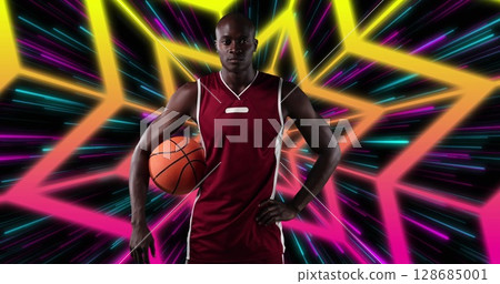 African american male basketball player holding a basketball against star shapes in seamless pattern 128685001