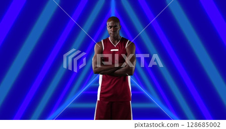 Image of african american male basketball player with arms crossed over shapes 128685002