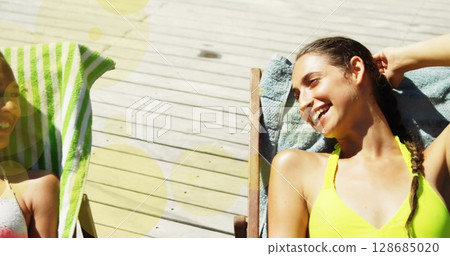 Image of spots over happy diverse female friends lying on sunbeds Image of spots over happy diverse female friends lying on sunbeds 128685020