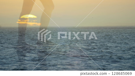 Image of landscape with ocean over caucasian woman walking at beach Image of landscape with ocean over caucasian woman walking at beach 128685069