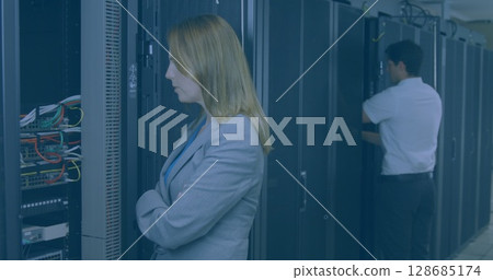 Image of shapes over diverse workers inspecting server room 128685174