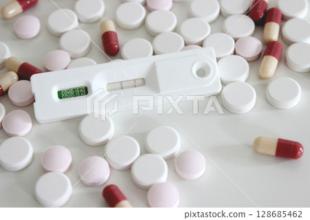 Positive test result of Covid-19 antigen test kit and drugs isolated on the white background Positive test result of Covid-19 antigen test kit and drugs isolated on the white background 128685462