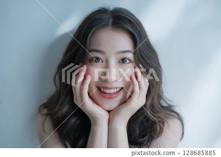 A young Japanese woman smiling in surprise Generative AI 128685885