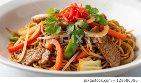 Close-up shot of a delicious, colorful serving of Asian noodles with vegetables and meat. 128686386
