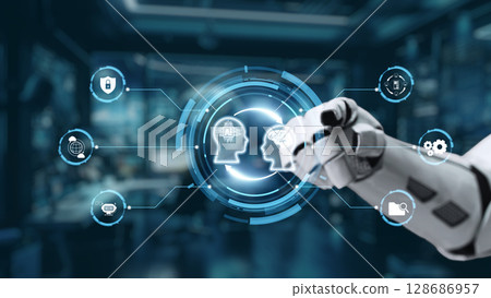 Robotic Hand Interacting with Digital Interface Representing Artificial Intelligence and Human Thought in Futuristic Laboratory Environment. Auvana Robotic Hand Interacting with Digital Interface Representing Artificial Intelligence and Human Thought in Futuristic Laboratory Environment. Auvana 128686957
