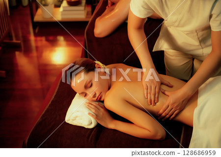Caucasian couple customer enjoying relaxing anti-stress massage. Quiescent Caucasian couple customer enjoying relaxing anti-stress massage. Quiescent 128686959