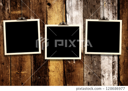 Photos hanging on paper clips against wall. Nostalgic Picture album with old photoframe. Template with three retro frame photos. Moodboard pictures album for scrapbooking. Vintage style mood board 128686977