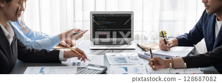 Analyst team working on data analysis dashboard on laptop screen. Insight Analyst team working on data analysis dashboard on laptop screen. Insight 128687082