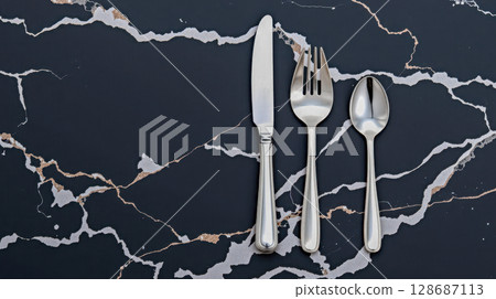 Vintage silver cutlery set on black marble background with copy space, elegant antique flatware for luxury table setting, formal dinner or exclusive restaurant menu Vintage silver cutlery set on black marble background with copy space, elegant antique flatware for luxury table setting, formal dinner or exclusive restaurant menu 128687113