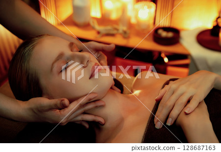 Caucasian woman enjoying relaxing anti-stress head massage. Quiescent Caucasian woman enjoying relaxing anti-stress head massage. Quiescent 128687163