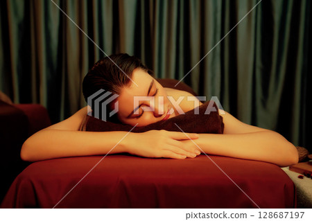Caucasian woman customer enjoying relaxing anti-stress massage. Quiescent Caucasian woman customer enjoying relaxing anti-stress massage. Quiescent 128687197