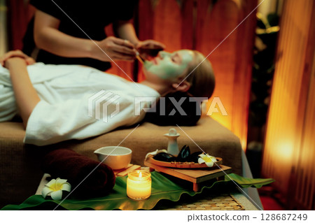 Woman indulges in rejuvenating with luxurious face cream spa massage. Quiescent 128687249