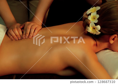 Caucasian woman customer enjoying relaxing anti-stress massage. Quiescent Caucasian woman customer enjoying relaxing anti-stress massage. Quiescent 128687310