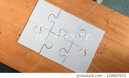 Top down view of business man gather last piece to complete puzzle. Convocation. 128687655