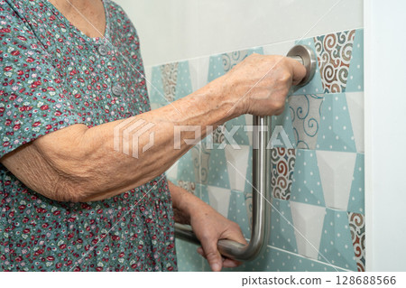 Asian elderly woman patient use toilet bathroom handle security in nursing hospital, healthy strong medical. Asian elderly woman patient use toilet bathroom handle security in nursing hospital, healthy strong medical. 128688566