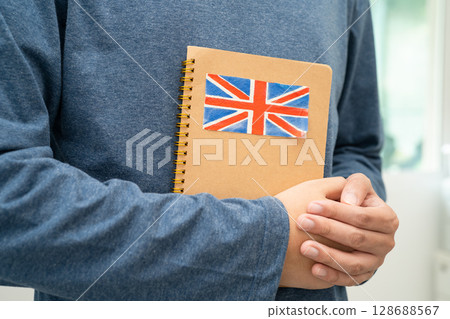 Learn English language, Asian teenage student hold book with flag in course at school. Learn English language, Asian teenage student hold book with flag in course at school. 128688567