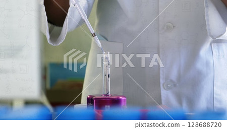 Image of chemical formulas over hands of african american female lab worker with sample Image of chemical formulas over hands of african american female lab worker with sample 128688720