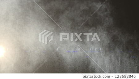 Image of light spots and smoke trails on black background Image of light spots and smoke trails on black background 128688846