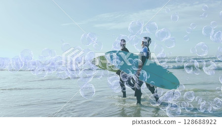 Image of bubbles over senior african american couple with surfboards on sunny beach Image of bubbles over senior african american couple with surfboards on sunny beach 128688922