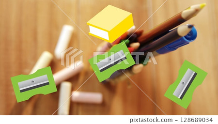 Image of yellow schoolbooks and green pencil sharpeners moving over crayons and pens on desk Image of yellow schoolbooks and green pencil sharpeners moving over crayons and pens on desk 128689034