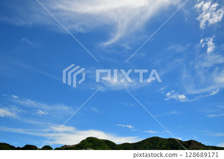 Blue sky, white clouds, contrails 128689171