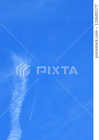 Blue sky, white clouds, contrails 128689177