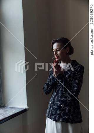 Fashionable woman in skirt and jacket climbing stairs Fashionable woman in skirt and jacket climbing stairs 128689276