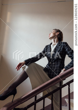Portrait of a beautiful fashionable woman in a skirt and jacket Portrait of a beautiful fashionable woman in a skirt and jacket 128689281