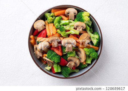 Stir fried vegetables, champignon mushroom, broccoli, bell pepper and carrot with soy sauce 128689617