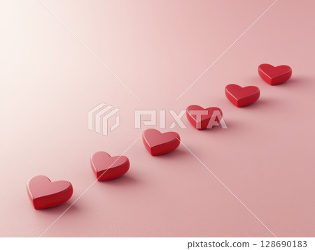 Red heart shapes arranged diagonal line soft pink background, symbolizing love and affection 128690183