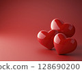 Glossy red heart shapes grouped on smooth red background with romantic feeling 128690200