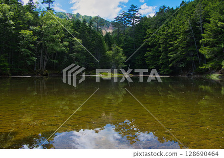 Midori Pond and Mount Tengu in the Yatsugatake Mountains Midori Pond and Mount Tengu in the Yatsugatake Mountains 128690464