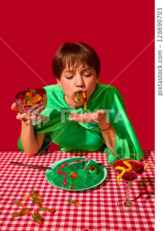 Woman with closed eyes joyfully stuffing gummy worms into mouth at vibrant dessert table Woman with closed eyes joyfully stuffing gummy worms into mouth at vibrant dessert table 128690703