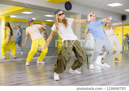 Team of dancers performing hip hop dance in ball room 128690785