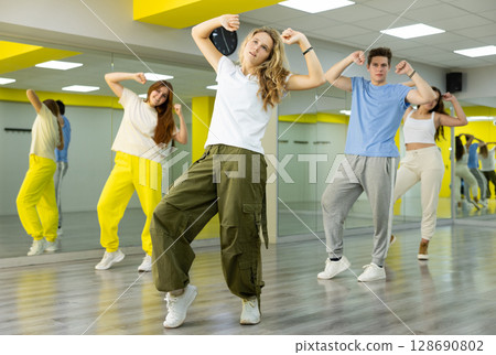 Teenage girl training breakdance Toprock moves in dance hall 128690802