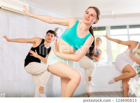 Group of young people dancing indoors. Group of young people dancing indoors. 128690813