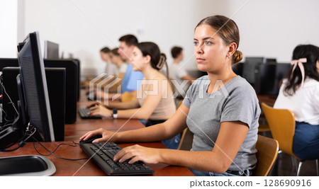 Portrait of young female student studying in computer class 128690916